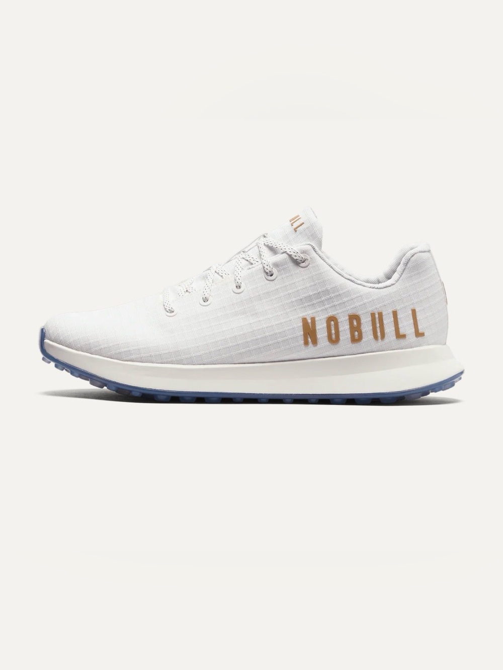 NOBULL White Athletic Trainer with Gold Branding and Blue Outsole